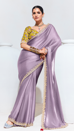 Woman wearing a lavender saree with gold border on a white background