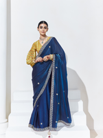 Woman wearing a blue saree with a white background
