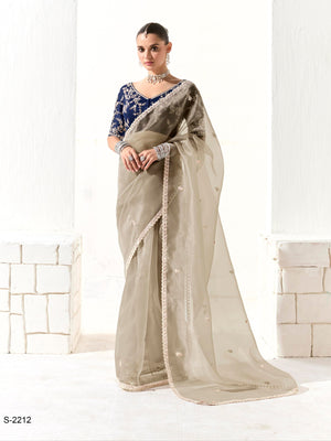 Woman wearing a saree with a kimora label on a white background