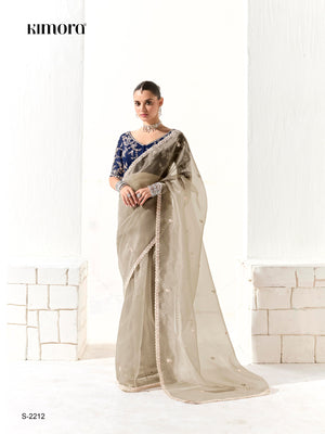 Woman wearing a saree with a kimora label on a white background