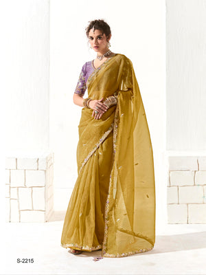 Woman wearing a green saree with a white background, featuring the brand 'Kimora'.