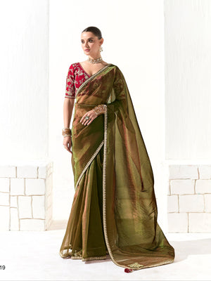 Woman wearing a green saree with a red blouse against a white background, branded 'Kimora'.
