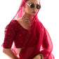 Woman wearing a red embroidered saree with sunglasses and jewelry on a white background