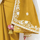 Mustard yellow traditional outfit with white embroidery on a plain background