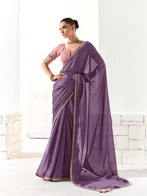 Woman wearing a purple saree with a white background
