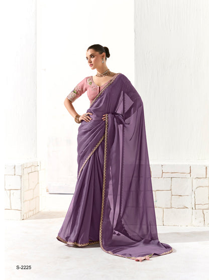 Woman wearing a purple saree with a white background
