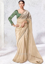 champagne soft silk saree with forest green printed blouse and gold sequin border
