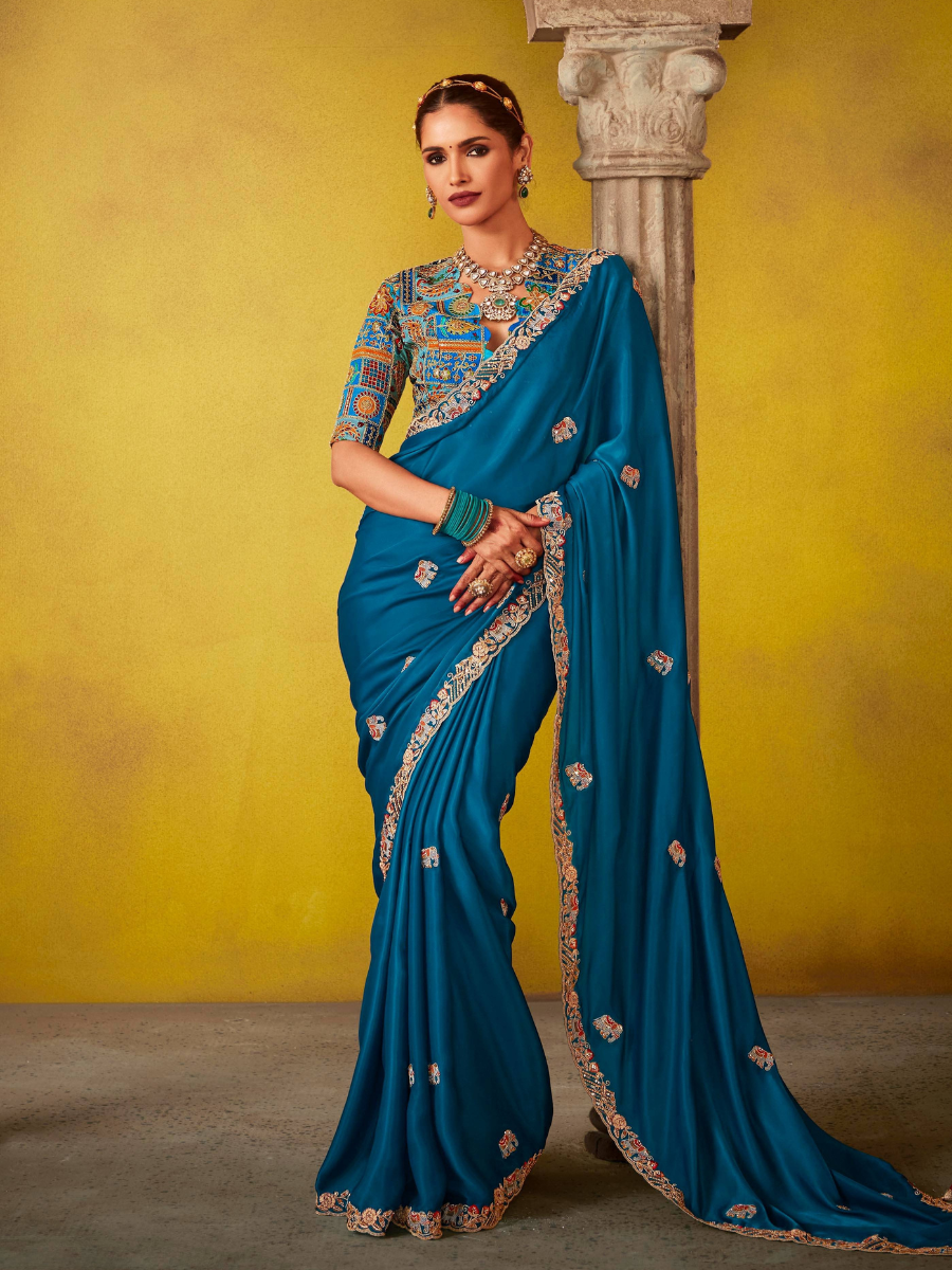 Gaj Pushpa Tissue Silk Saree In Peacock Blue