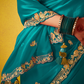Teal Green Tissue Silk Saree with Embroidered Border and Contrast Floral Blouse