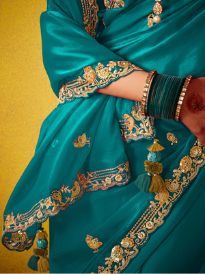 Teal Green Tissue Silk Saree with Embroidered Border and Contrast Floral Blouse