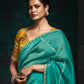 TEAL DESIGNER ORGANZA SAREE WITH HANDCRAFTED EMBROIDERED BORDER – BOLD, ELEGANT, UNFORGETTABLETeal Green Designer Organza Silk Saree
