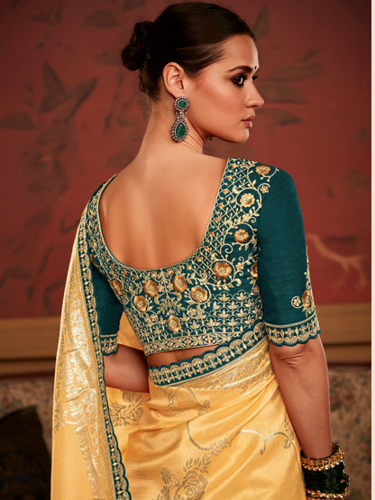 Yellow Designer Saree with Golden and Silver Zari Weaving, Dark Green Floral Embroidered Blouse and Wavy Border for Weddings and Festive Celebrations By Kimora
