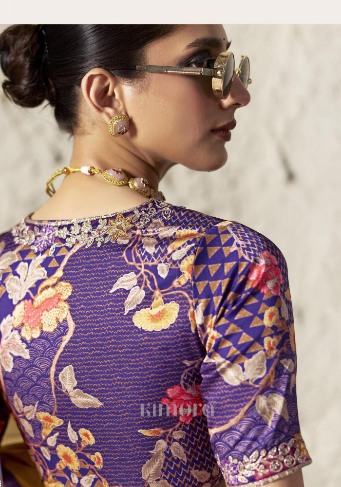 Woman wearing a patterned blouse with floral and geometric designs.