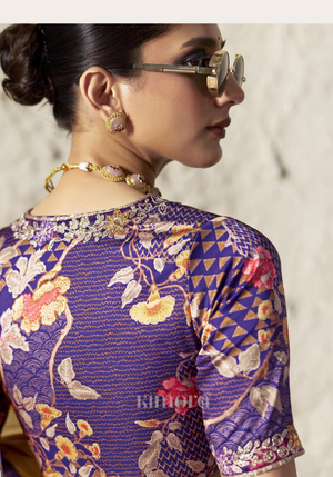 Woman wearing a patterned blouse with floral and geometric designs.