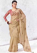 Champagne gold Mulberry Cotton Silk saree with zari, sequins and bead embroidery paired with a red digitally printed satin silk blouse by Kimora.