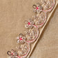 Close-up of the champagne gold saree showcasing intricate zari, sequins and bead embroidered floral border with elegant craftsmanship.