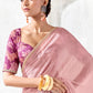 Designer blush pink Tissue Silk saree featuring an embroidered gold border and magenta floral printed blouse for weddings and festive occasions.