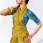 Designer chartreuse yellow tissue silk saree featuring an embroidered border and teal multicolour printed blouse for festive occasions.