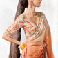 Designer ivory and burnt orange ombre tissue silk saree featuring an embroidered floral border and digitally printed satin silk blouse.