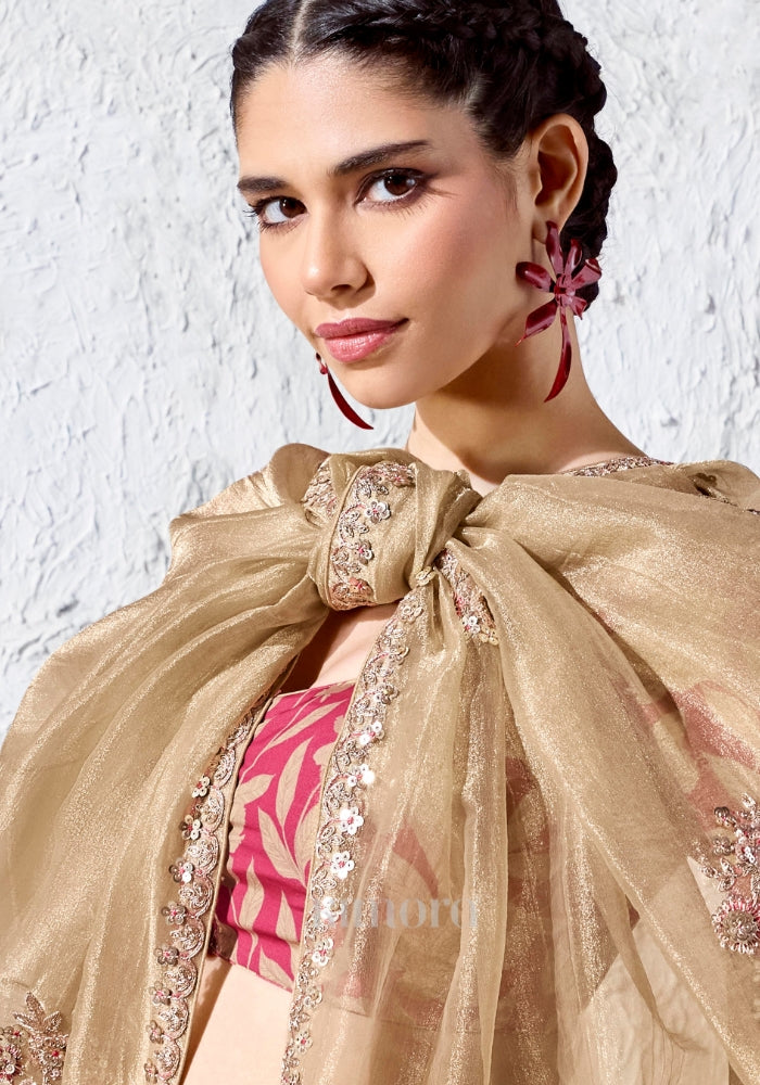 Elegant champagne gold festive saree with scattered floral motifs, zari embroidery and red printed blouse, ideal for weddings and festive occasions.