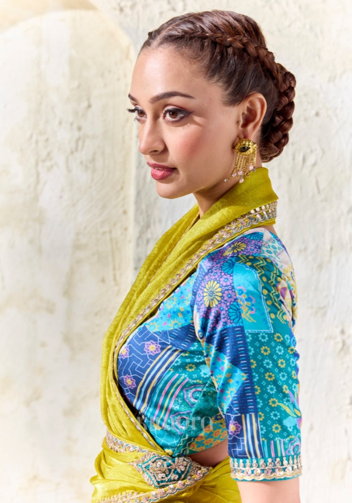 Elegant chartreuse yellow festive saree with shimmering tissue silk fabric, embroidered border and teal printed blouse for haldi and wedding celebrations.