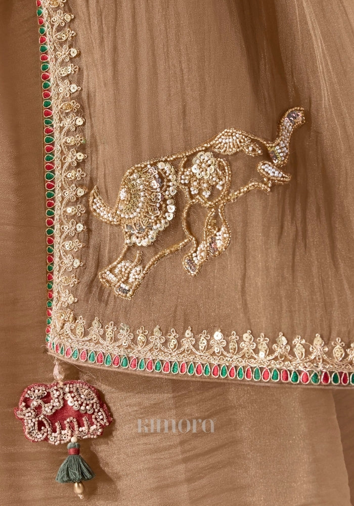 Gold soft silk saree with embroidered elephant pallu, ruby emerald border and elephant tassel