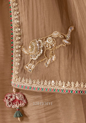 Gold soft silk saree with embroidered elephant pallu, ruby emerald border and elephant tassel