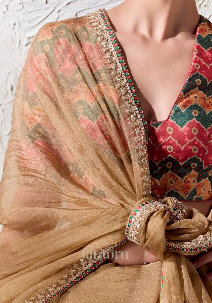 Gold soft silk saree with ruby emerald border and embroidered elephant tassel
