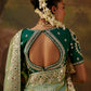 Back view of a woman wearing a dark green embroidered blouse