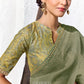 Green and gold digitally printed satin silk blouse with paisley print paired with a premium sage green embroidered Tissue Silk saree.