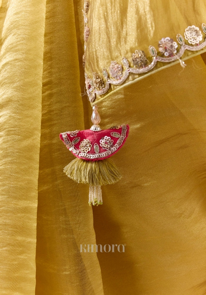 Olive gold soft silk saree with silver sequin border and embellished tassel detail