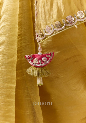 Olive gold soft silk saree with silver sequin border and embellished tassel detail
