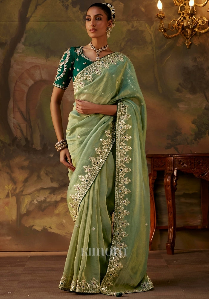 Woman wearing a luxurious green silk saree 