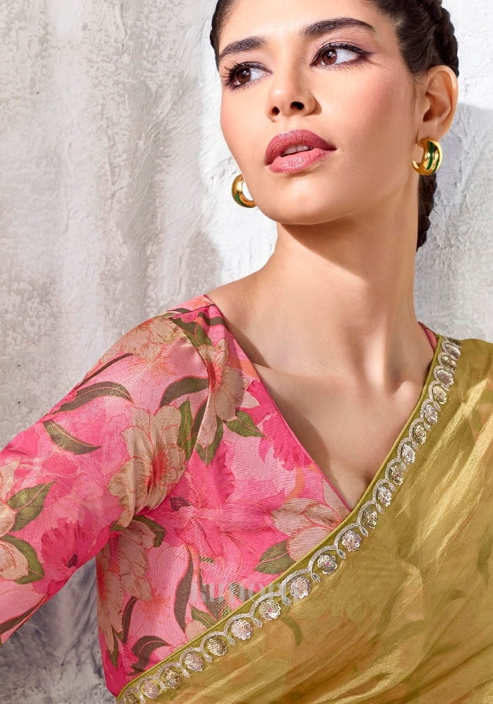 Pink linen satin blouse with oversized botanical floral print paired with olive gold saree