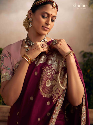 Woman in traditional attire with jewelry, featuring 'sindhuri' brand.