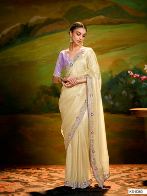 Woman in a light-colored saree with a scenic background
