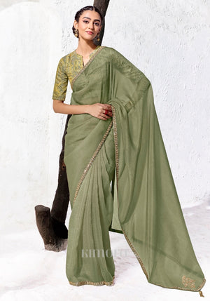 Sage green Tissue Silk saree with zari, sequins and bead embroidery paired with a green and gold digitally printed satin silk blouse by Kimora.