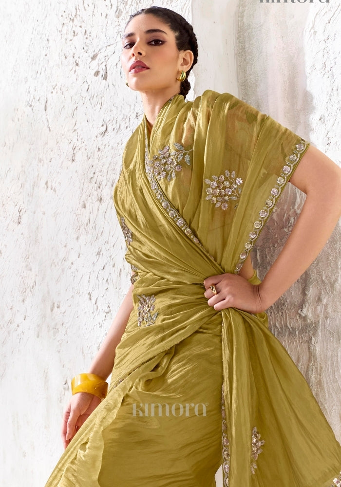 Soft silk olive gold saree featuring delicate silver sequin embroidered border