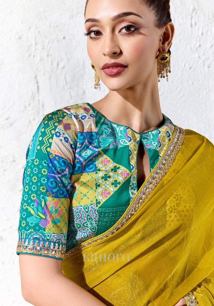 Teal digitally printed satin silk blouse with multicolour patchwork design paired with a premium chartreuse yellow tissue silk saree.