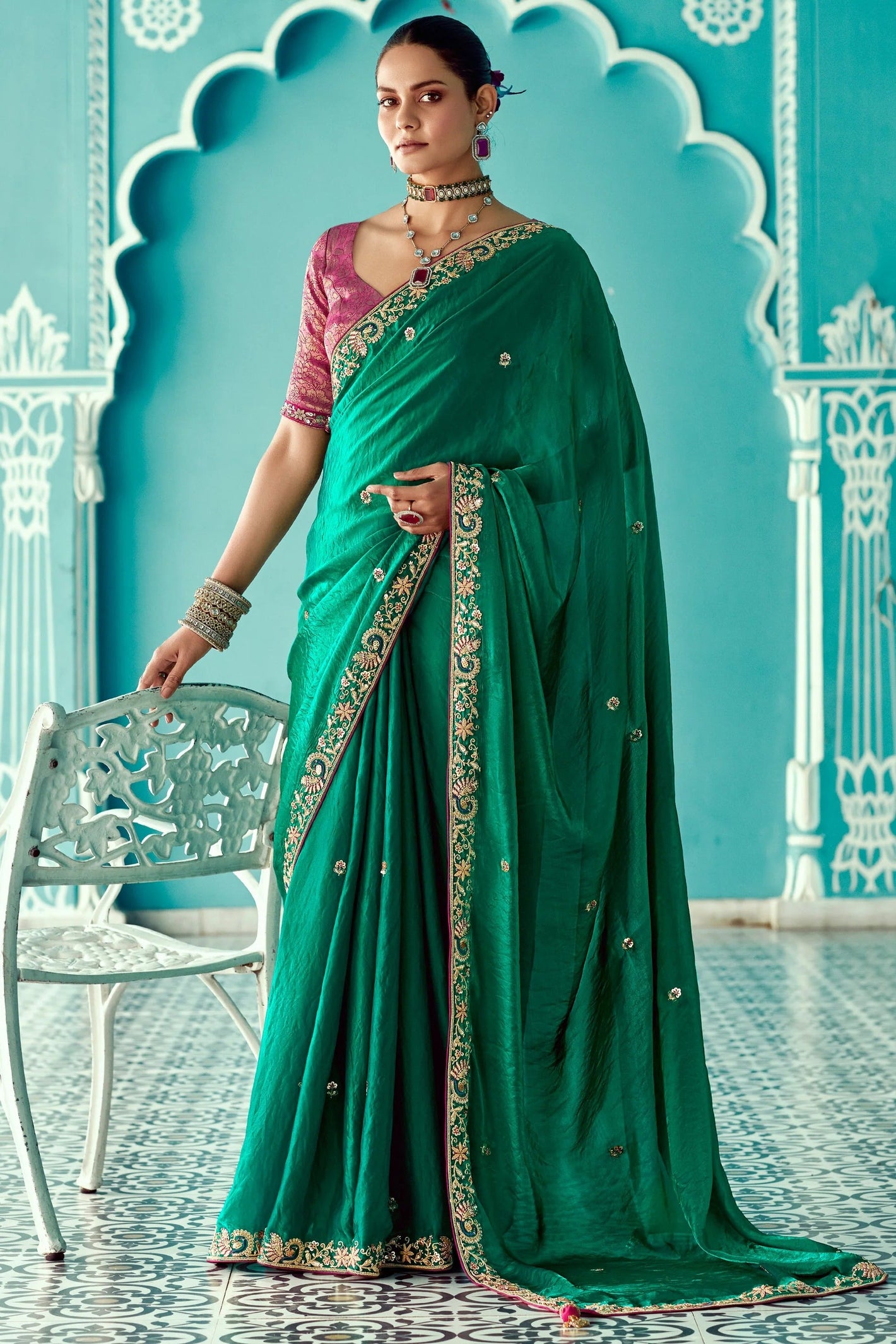 Woman in a green saree with gold embroidery 