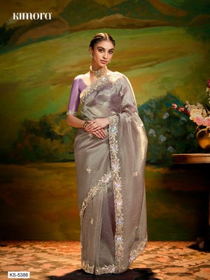 Woman in a silver saree with a scenic background