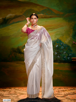 Woman in a white saree with a scenic background