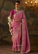  pink embroidered silk saree with a magenta blouse traditional