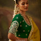 Back view of a woman in an intricately embroidered green blouse  
